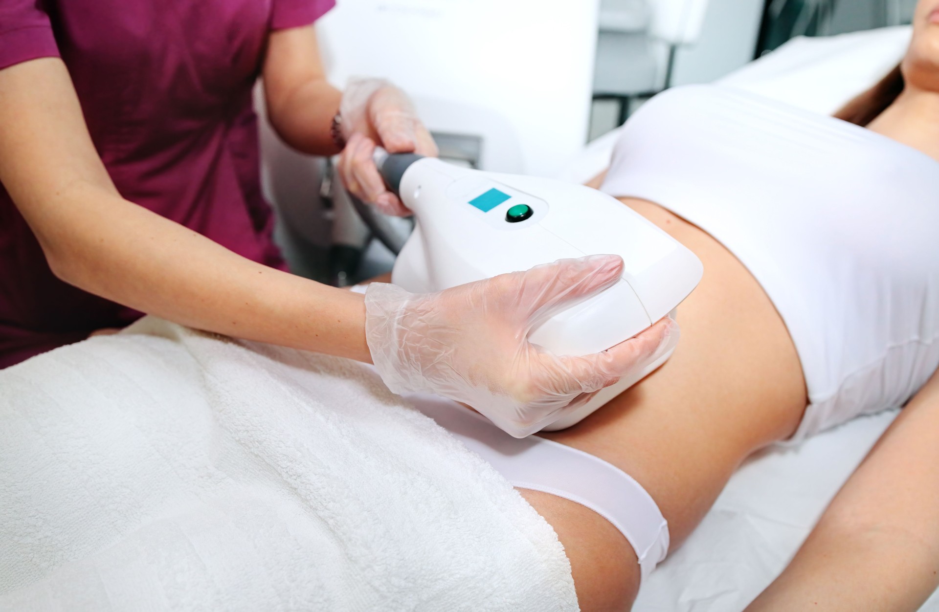 Attractive woman abdomen getting Cool sculpting procedure. Body slimming. Cryolipolyse and body contouring treatment, anti-cellulite and anti-fat therapy in beauty salon