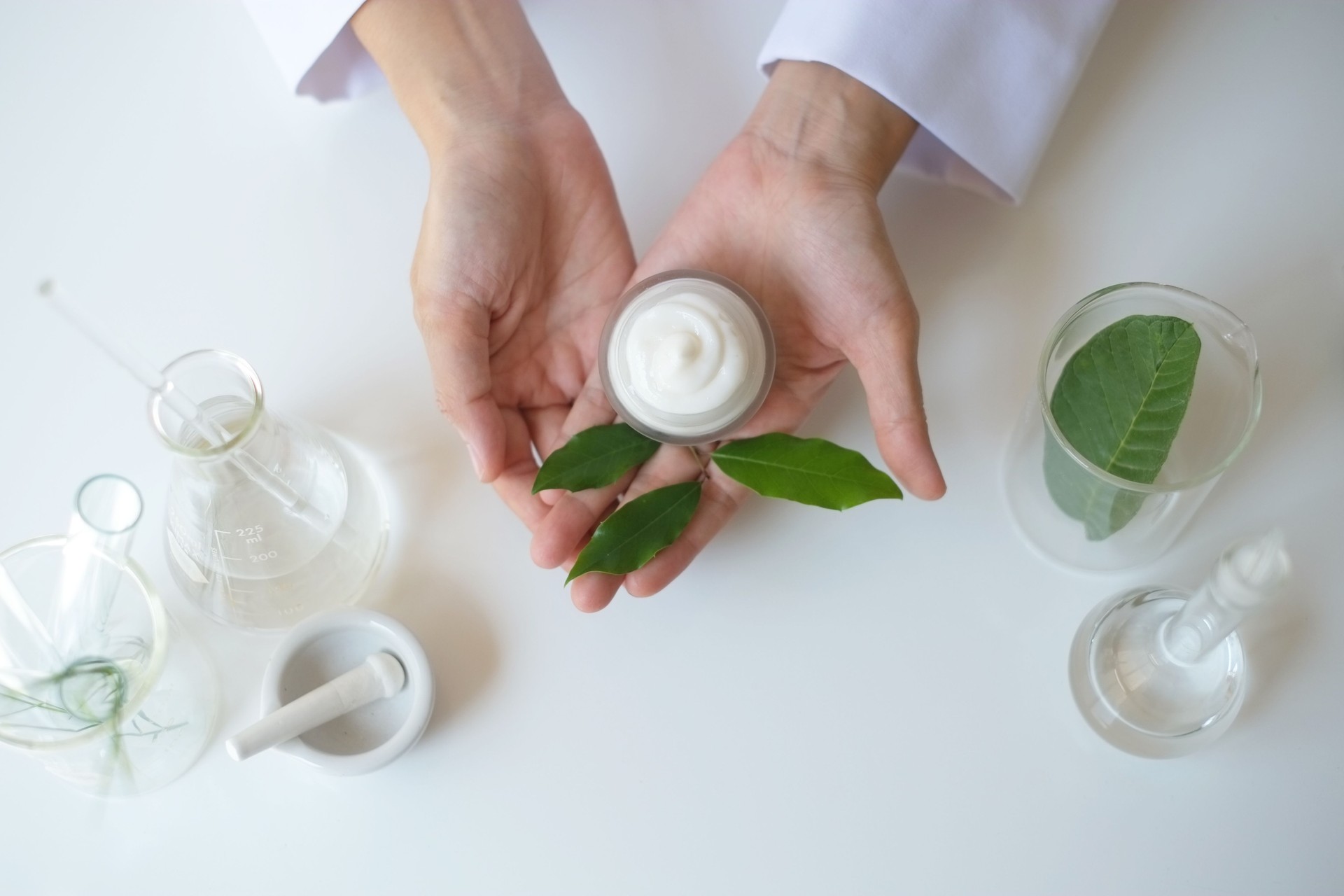 the scientist,dermatologist testing the organic natural product in the laboratory.research and development beauty skincare concept.blank package,bottle,container .cream,serum.