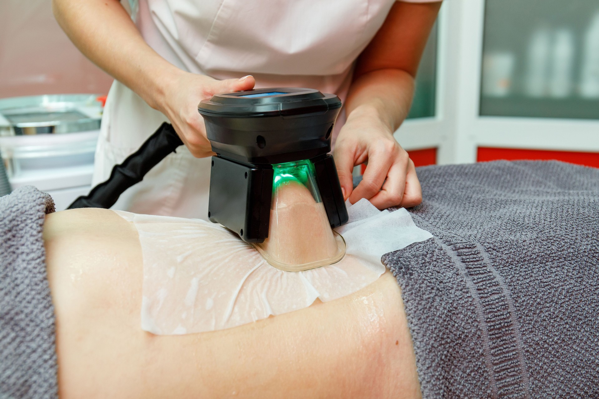 Beauty therapist applying cryolipolysis treatment. Non-surgical fat reduction